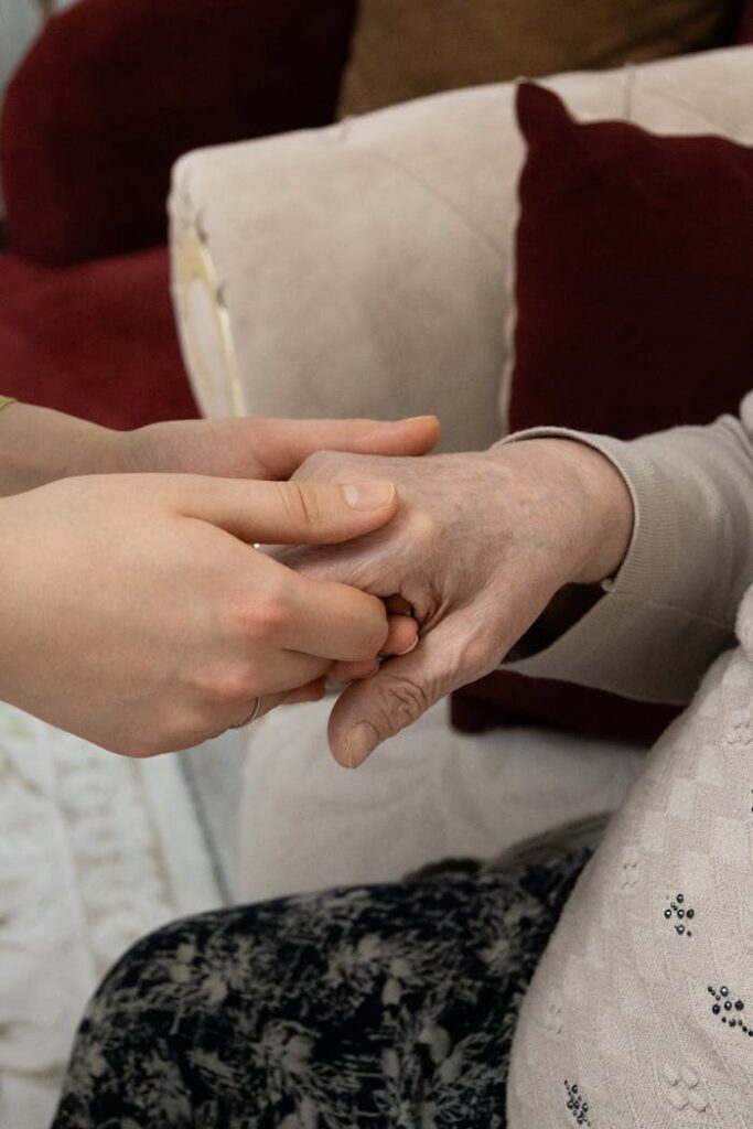 pexels-photo-36706840 A close-up of two hands showing support and care, symbolizing generational connection indoors.